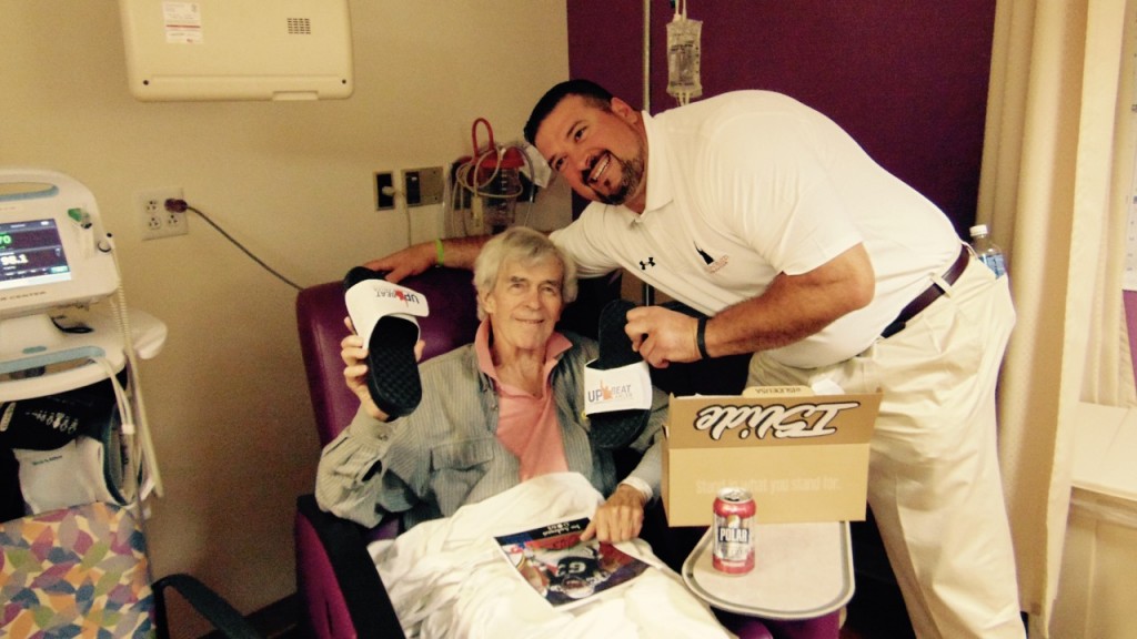 Joe Andruzzi giving Upbeat Cancer ISlides to patient at beth israel deaconess in Plymouth, MA