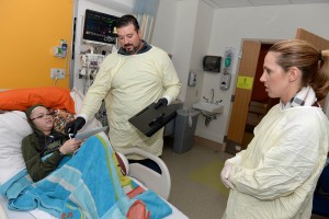 BOSTON, MA - JANUARY 26: Joe Andruzzi, and Jen Andruzzi (R) visit with Cameron at Boston Children